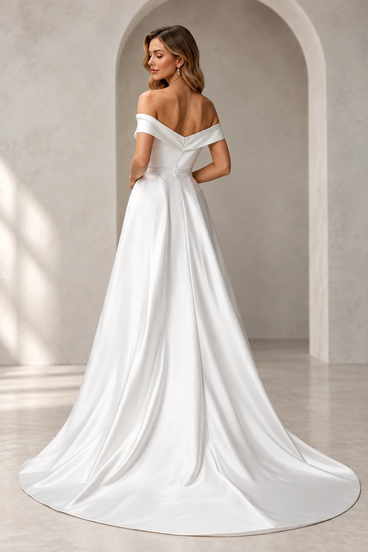 Back view of Vedress wedding dress with a folded low V-back, defined waistband and smooth sweeping train.